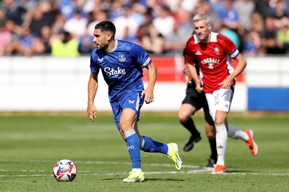 a soccer player wearing a blue jersey that says stake on it