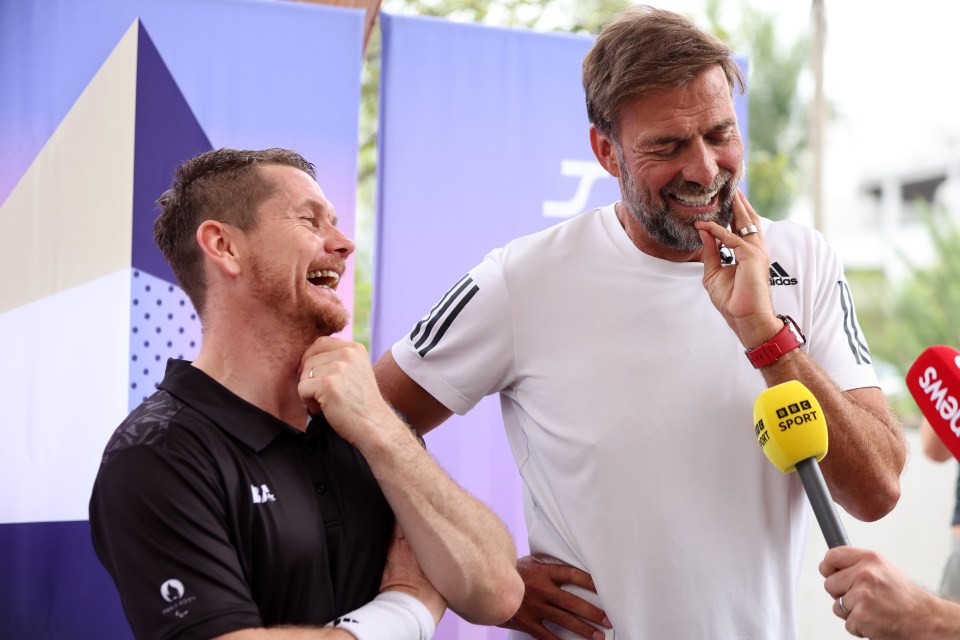 a man holding a microphone that says bbc sport on it