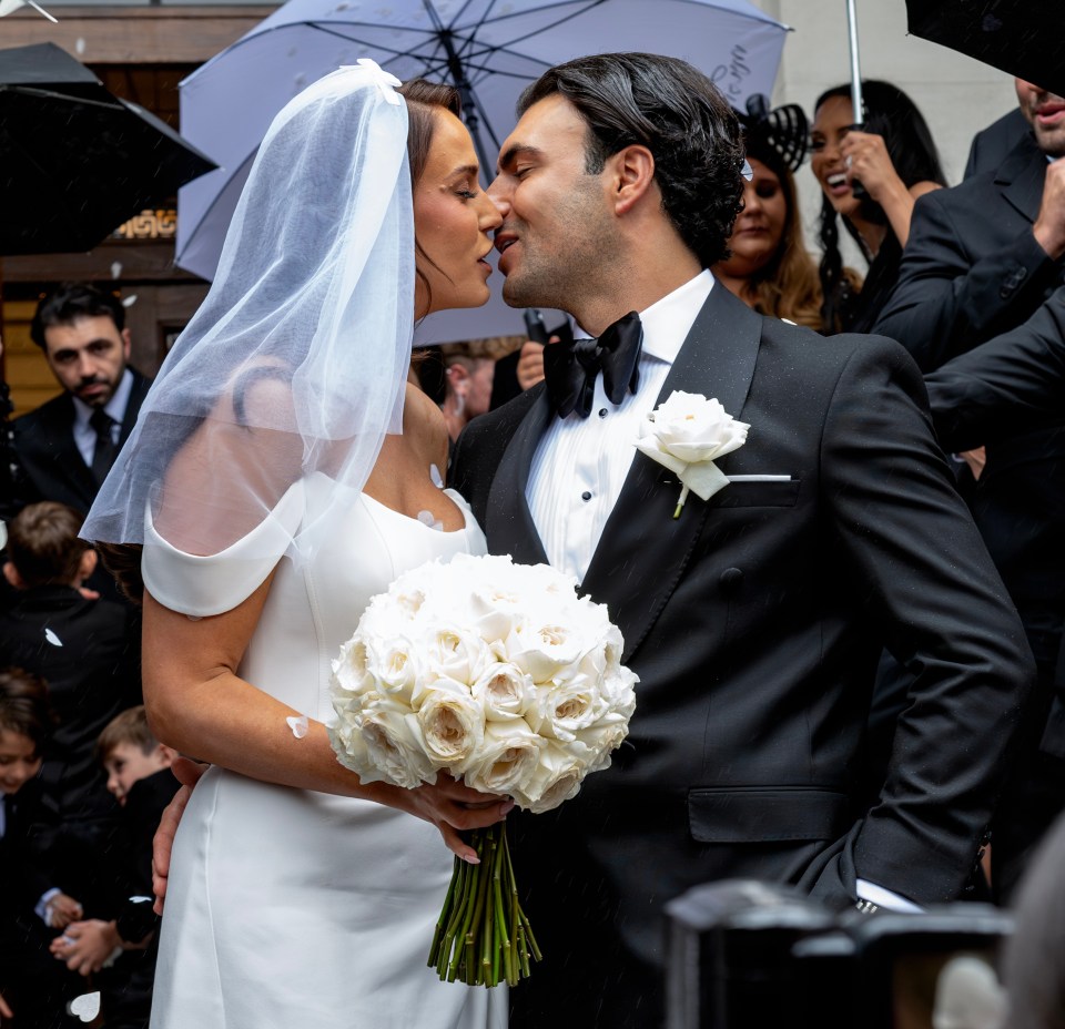 a bride and groom kissing under an umbrella that says ' umbrella ' on it