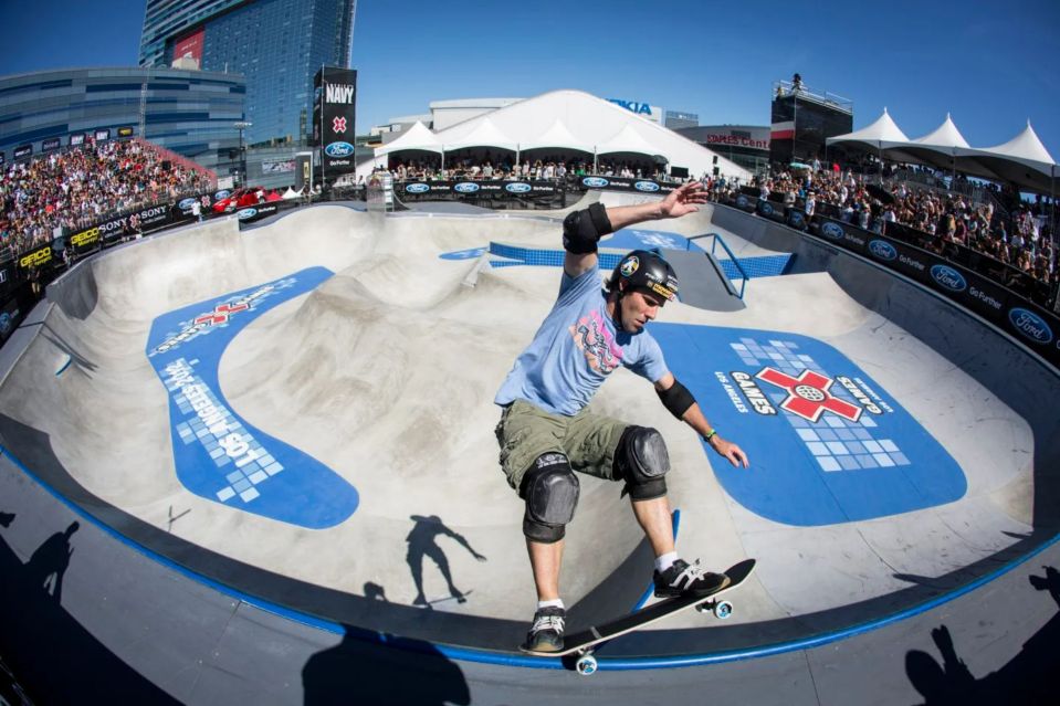 a man is riding a skateboard in a skate park sponsored by ford