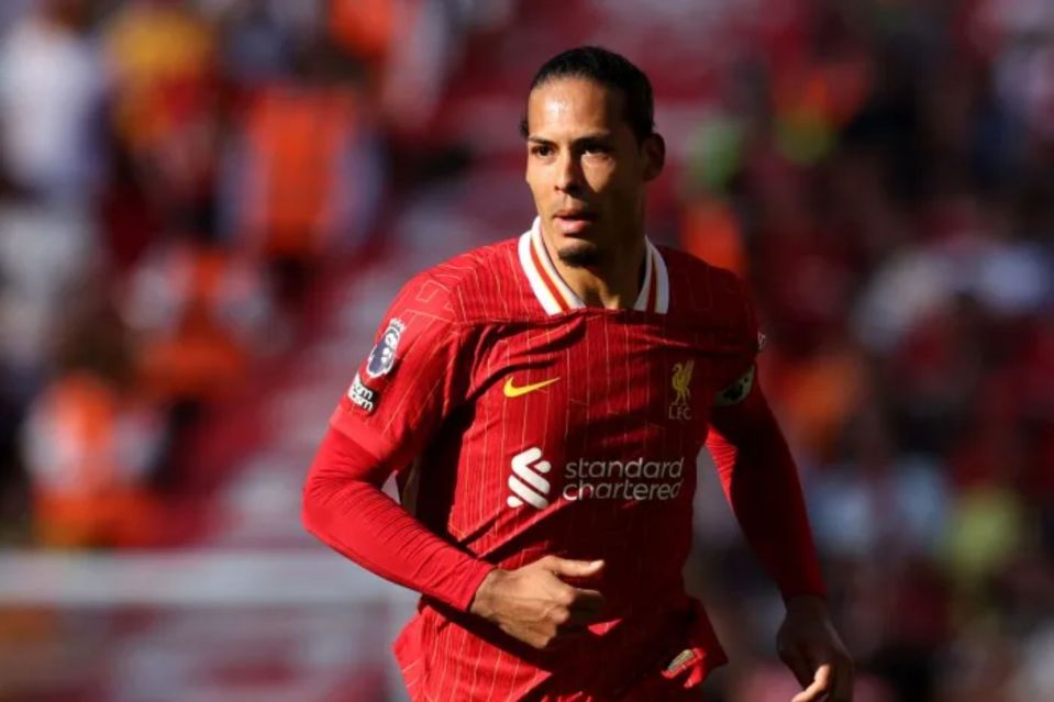 soccer player wearing a red jersey that says standard chartered