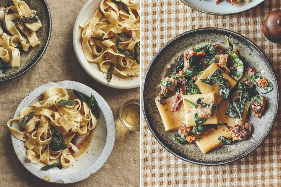 two plates of pasta with spinach and meat on a table