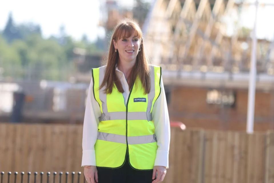 a woman wearing a yellow safety vest with a badge on it