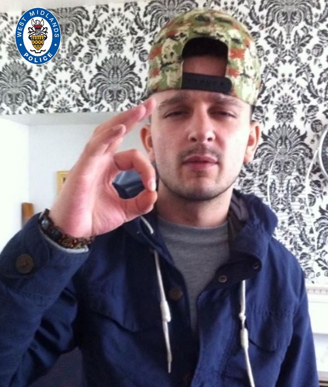 a man wearing a hat with the word west midlands on it