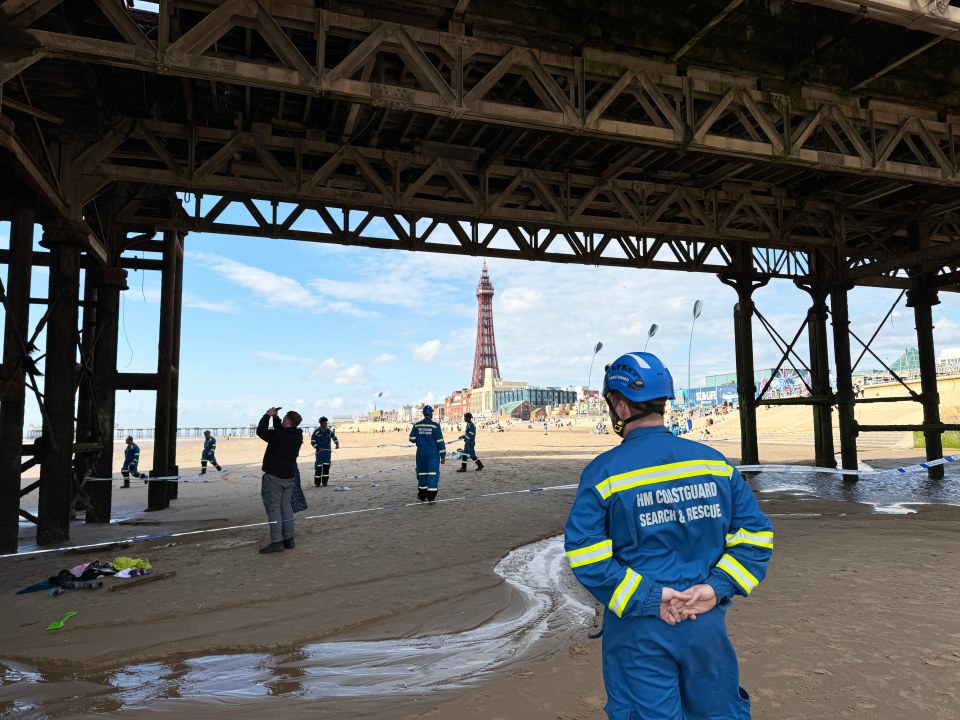 Members of the coastguard next to the cordon below Blackpool's Central Pier after the woman's horror fall on Tuesday