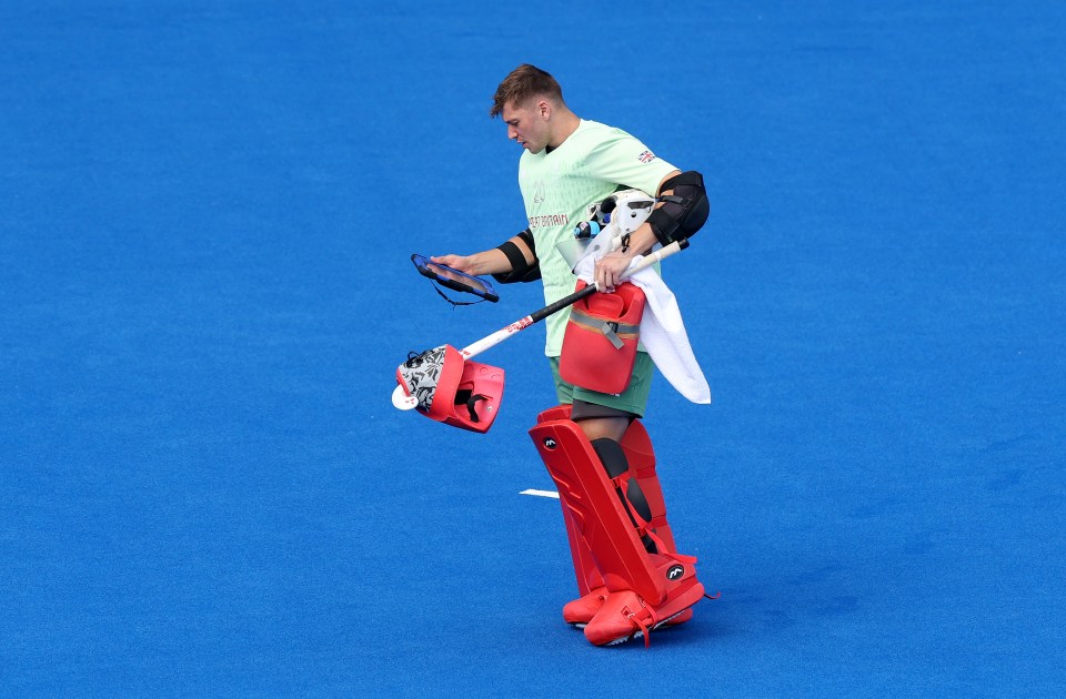 Team GB's Ollie Payne of Team Great Britain reads a tablet during the clash with India