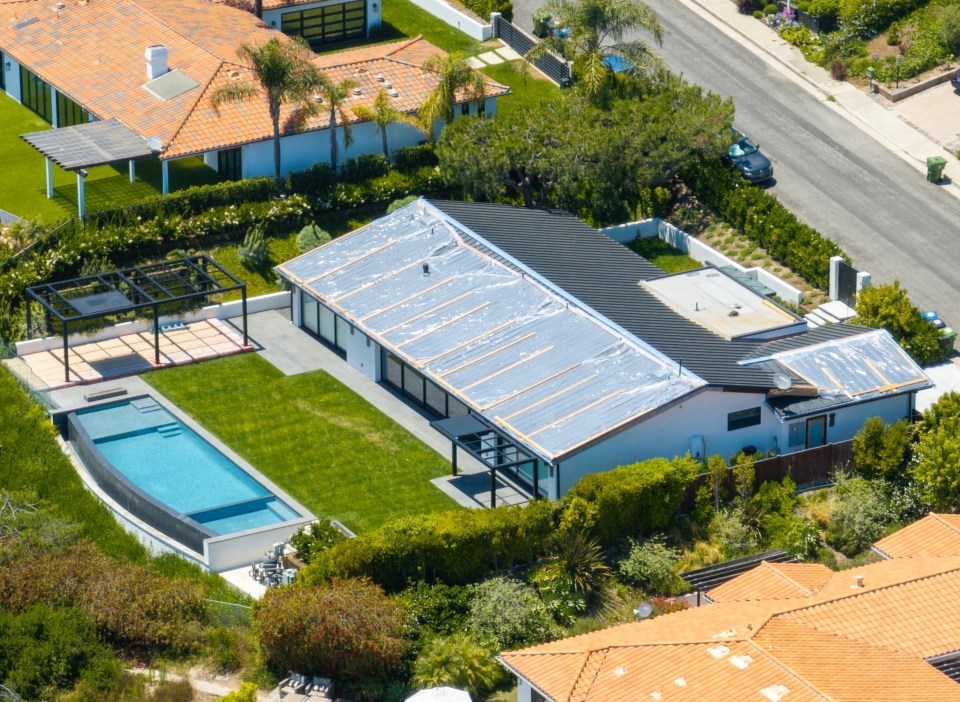 an aerial view of a house with a swimming pool