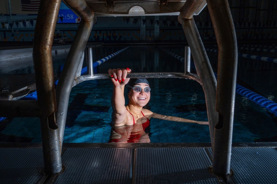 a woman in a swimming pool with a sign that says 1:58 on it