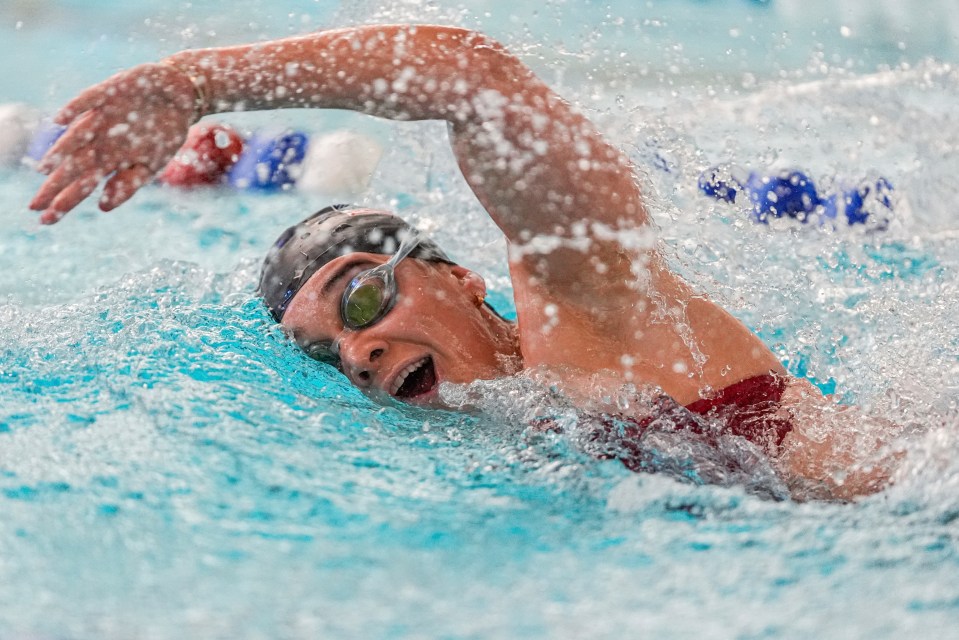 a person is swimming in a pool with a splash of water