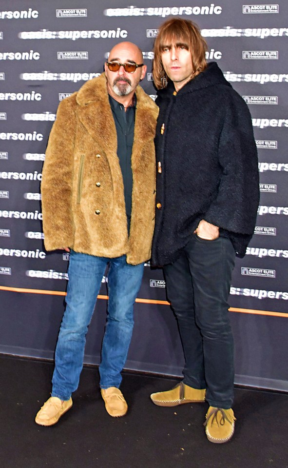 two men standing in front of a sign that says supersonic