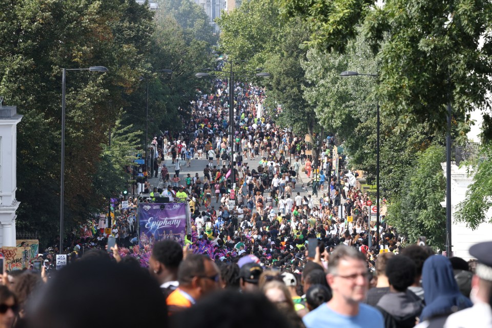 People walk on Ladbroke Grove during the Notting Hill Carnival