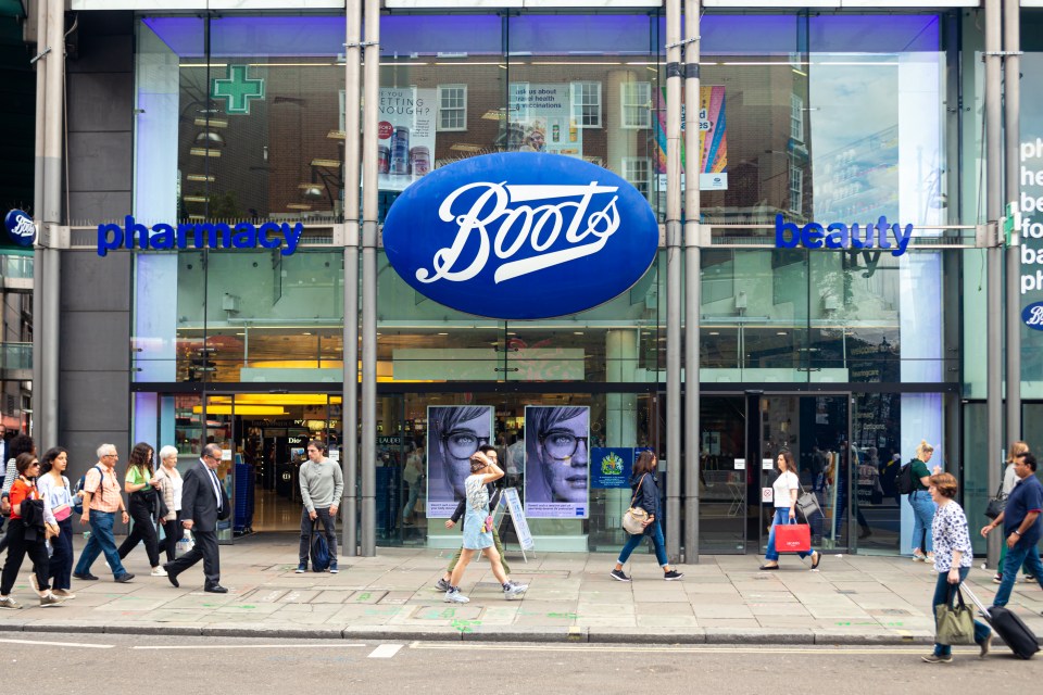 people walking in front of a boots pharmacy