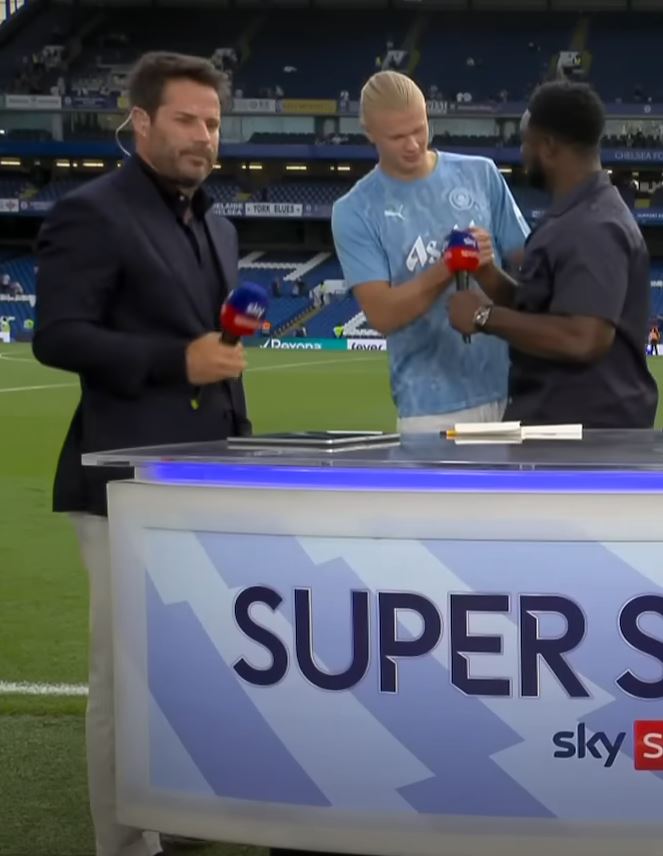 three men are standing in front of a sign that says super sky