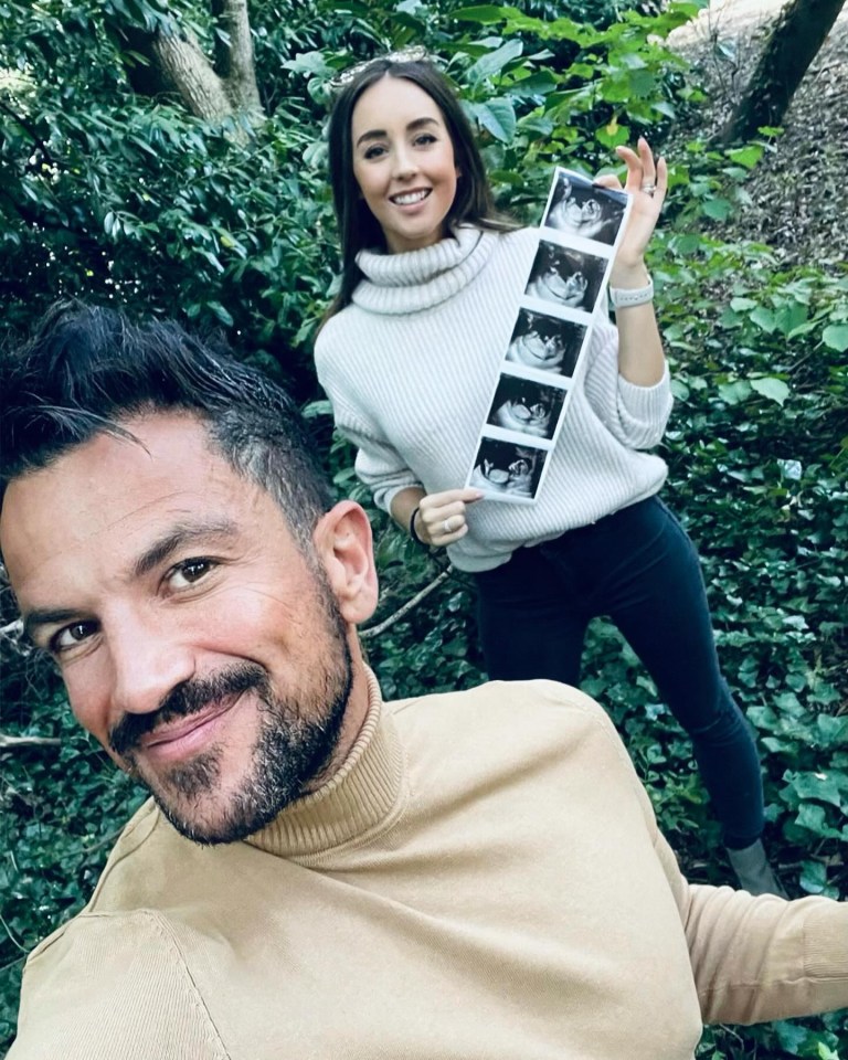 a man and a woman are posing for a picture in the woods