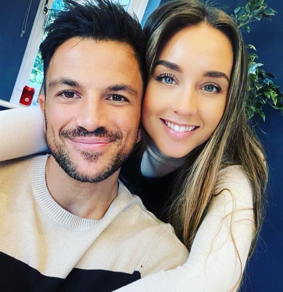 a man and a woman are posing for a picture and smiling for the camera