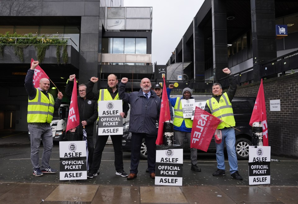 a group of men holding up signs that say aslef official picket