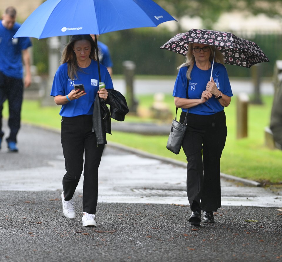 two women wearing blue shirts with the number 10 on them