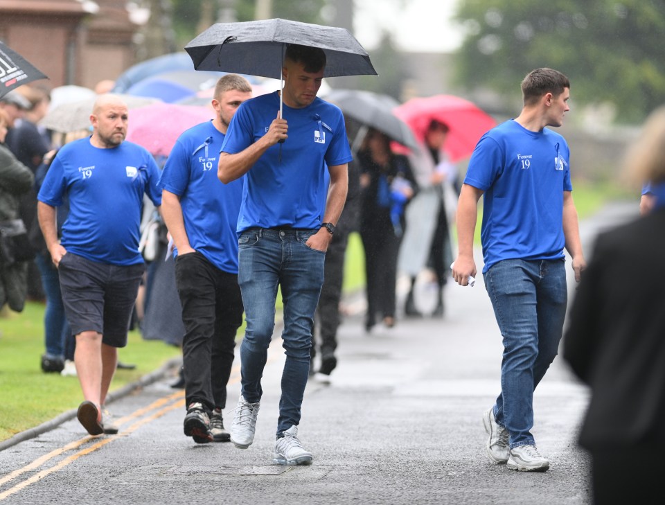 a group of people wearing blue shirts with the number 19 on them