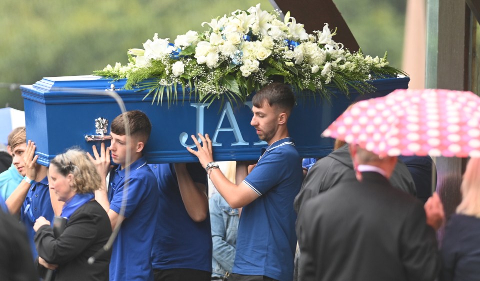 a blue coffin with the letter a on it