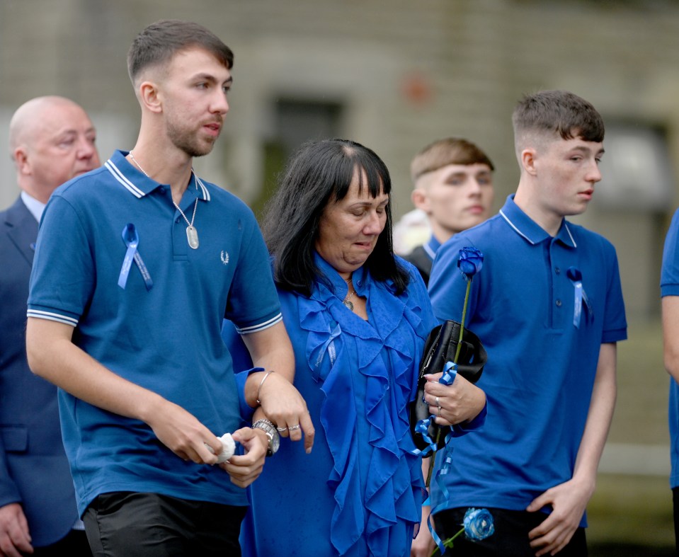 Debbie linked arms with son Zak, right, at Jay's emotional funeral