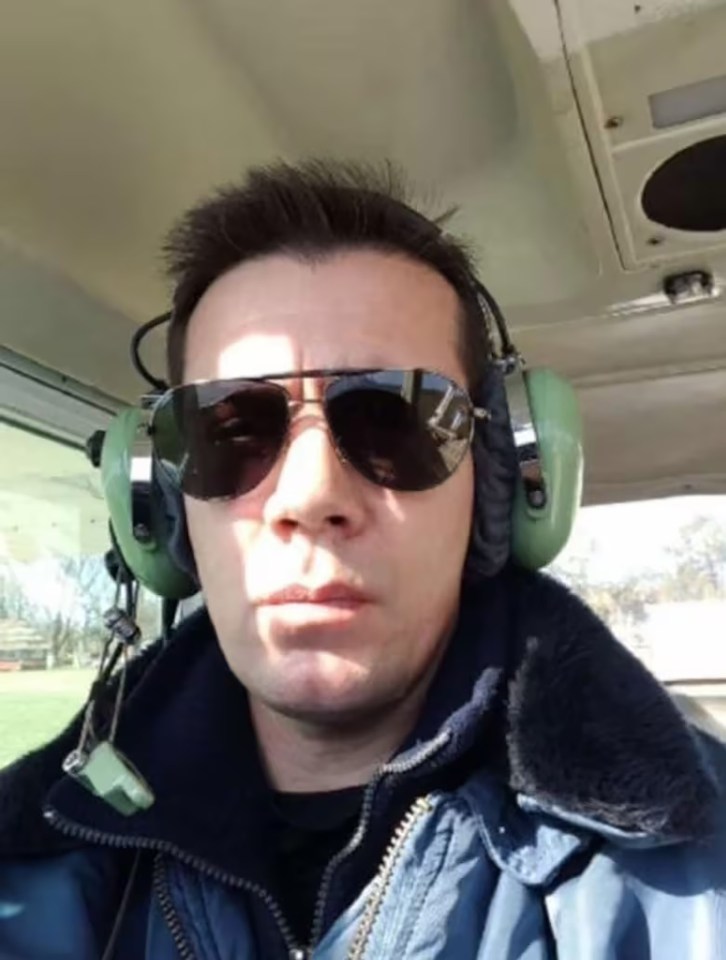 a man wearing sunglasses and headphones looks at the camera