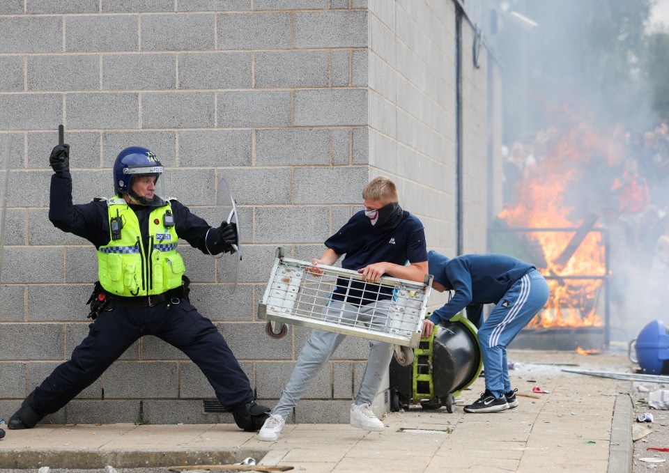 A police officer clashing with a protestor as the demonstration descended into chaos