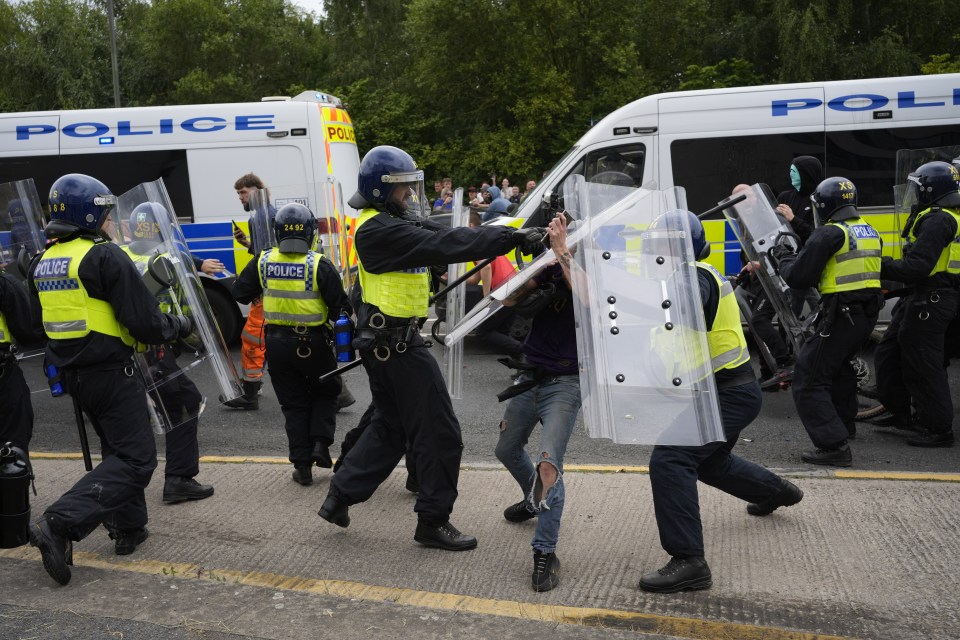 Police officers with protesters as trouble flares during an anti-immigration demonstration outside the Holiday Inn Express in Rotherham