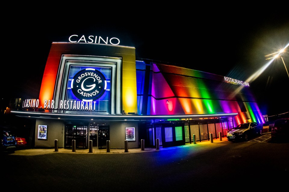 a casino with rainbow lights on the side of it