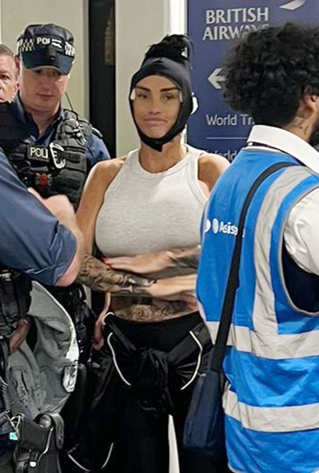 a woman wearing a helmet is standing in front of a british airways sign .