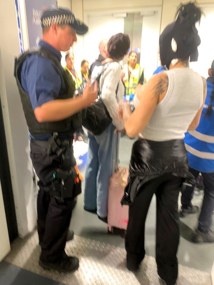 a man in a police uniform is talking to a woman