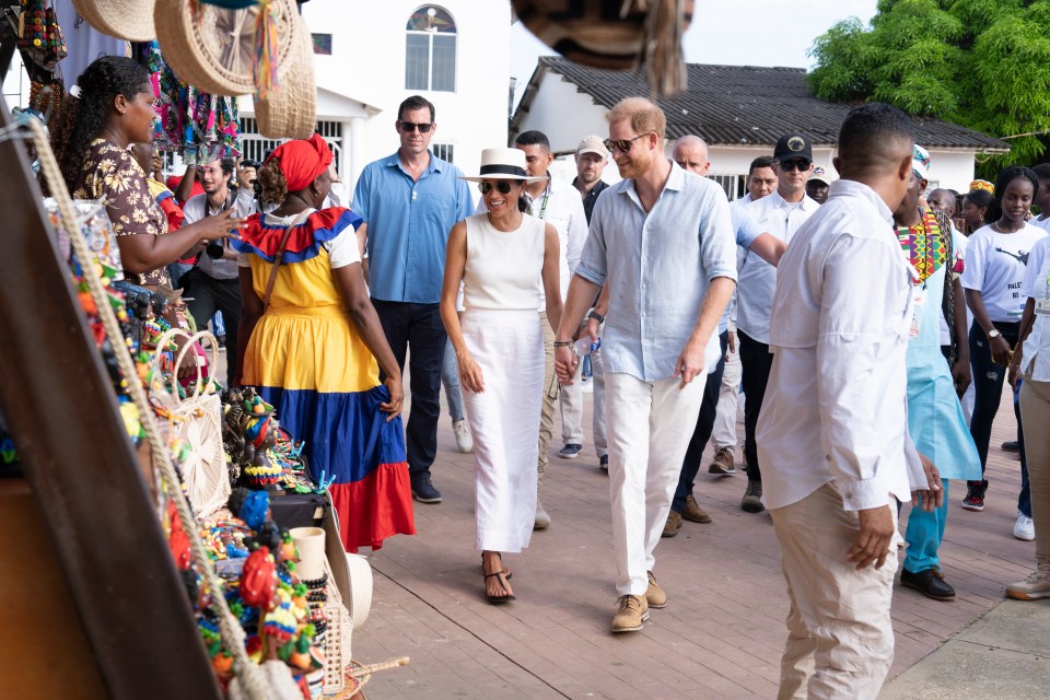 a group of people walking down a street holding hands