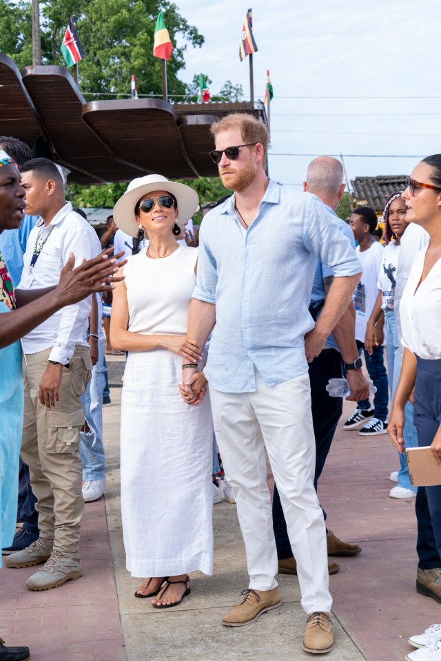 a man and a woman standing next to each other holding hands