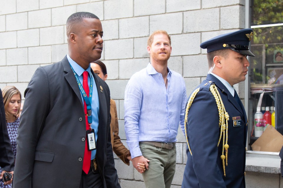 a man in a suit with a lanyard that says ' united nations ' on it