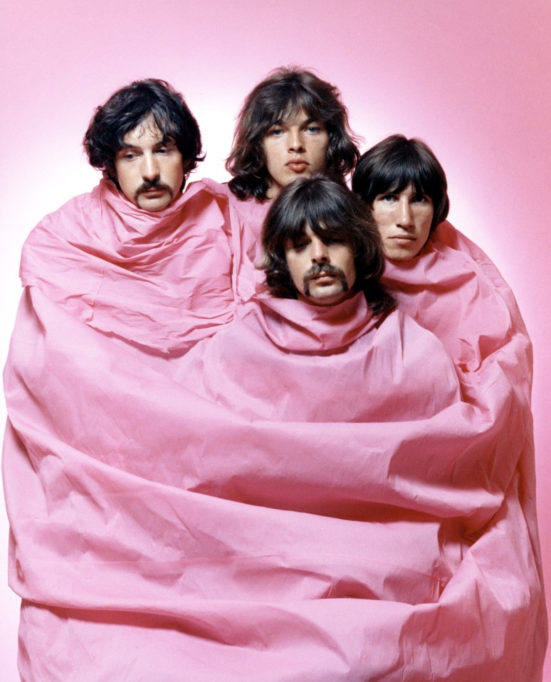 a group of men are wrapped in pink cloth