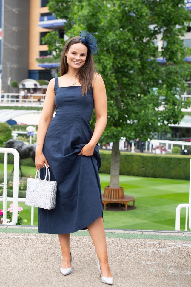 One woman donned a navy midi dress and matching fascinator