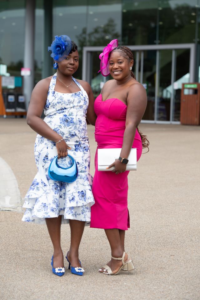 Two friends wowed in bold blue and pink midi dresses with matching accessories