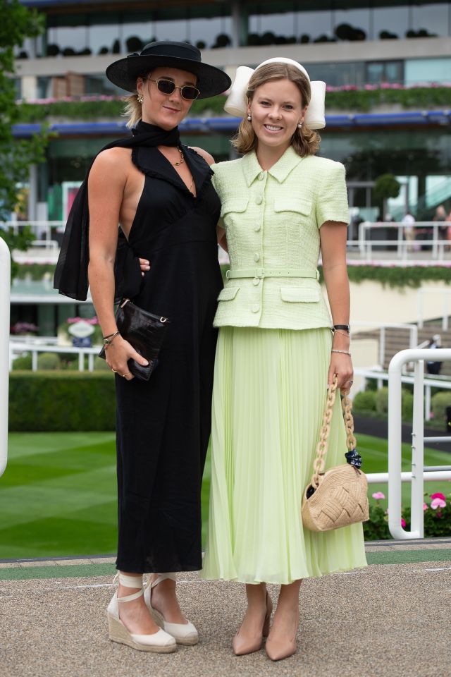 Two impeccably dressed friends smiled as they arrived at the racecourse