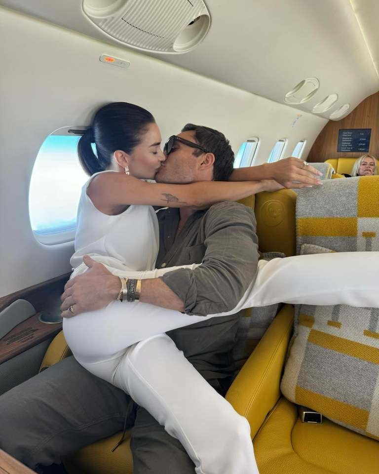 a man and a woman are kissing on a plane