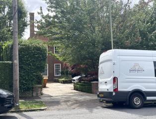 The red-brick mansion has a huge drive way and is shielded by trees for privacy