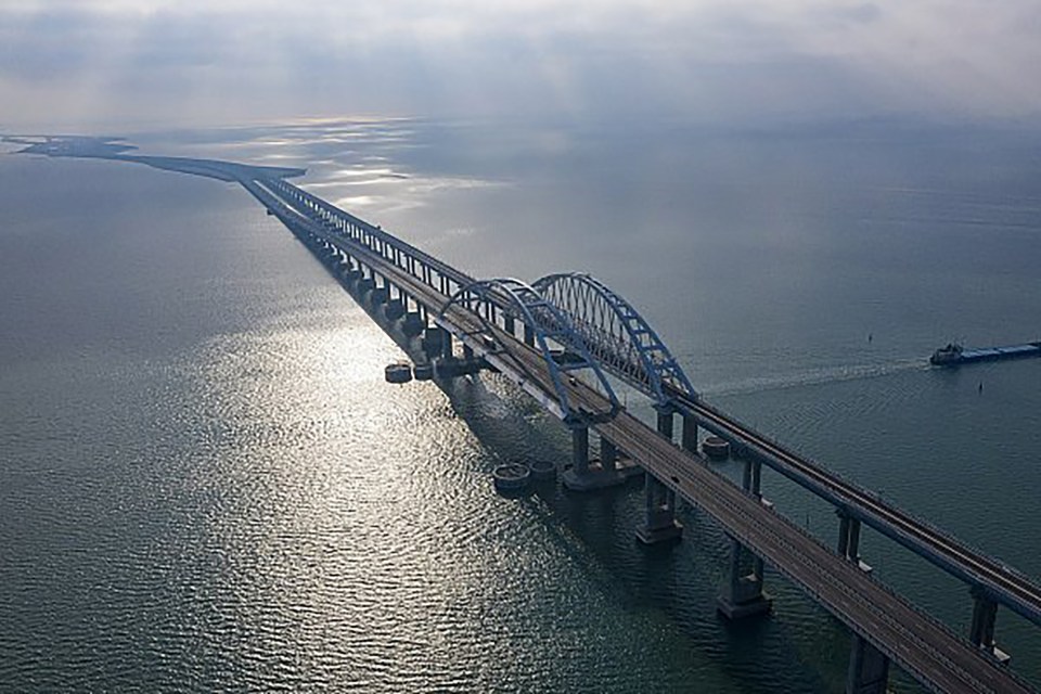 an aerial view of a bridge over a body of water