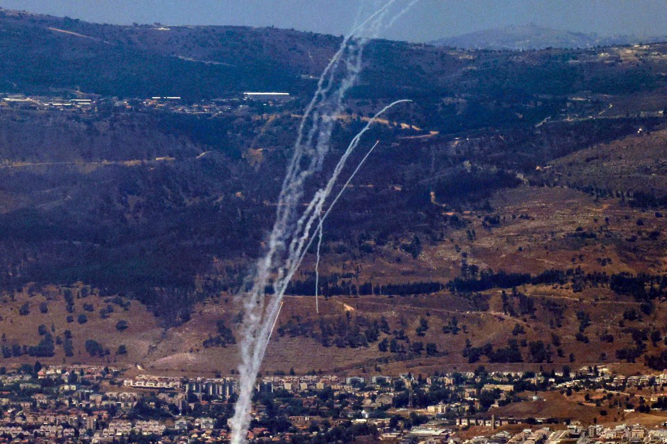 a bunch of white smoke coming out of a mountain