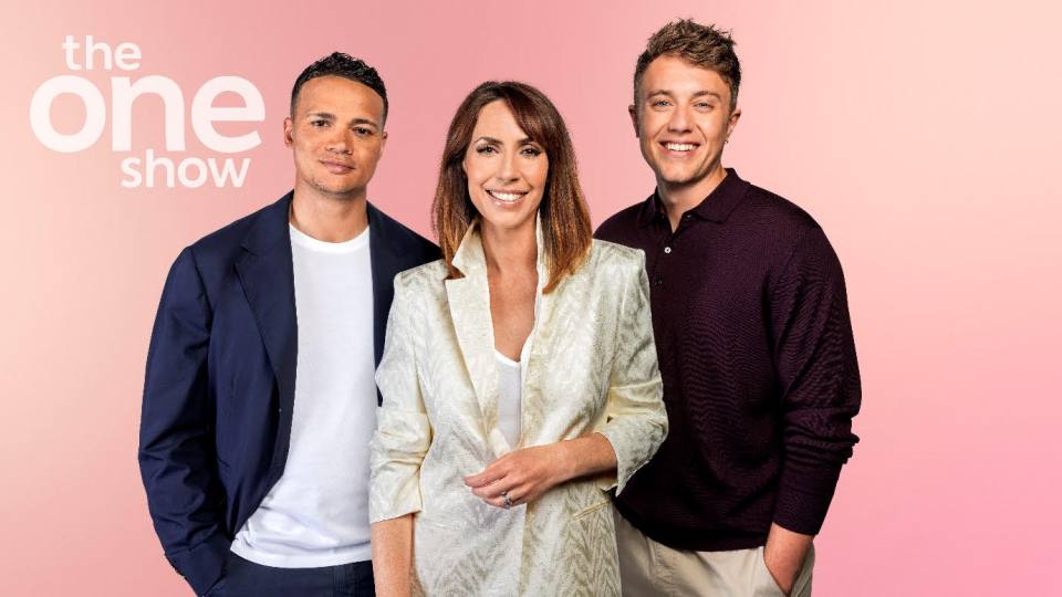 three people stand in front of a pink background that says the one show