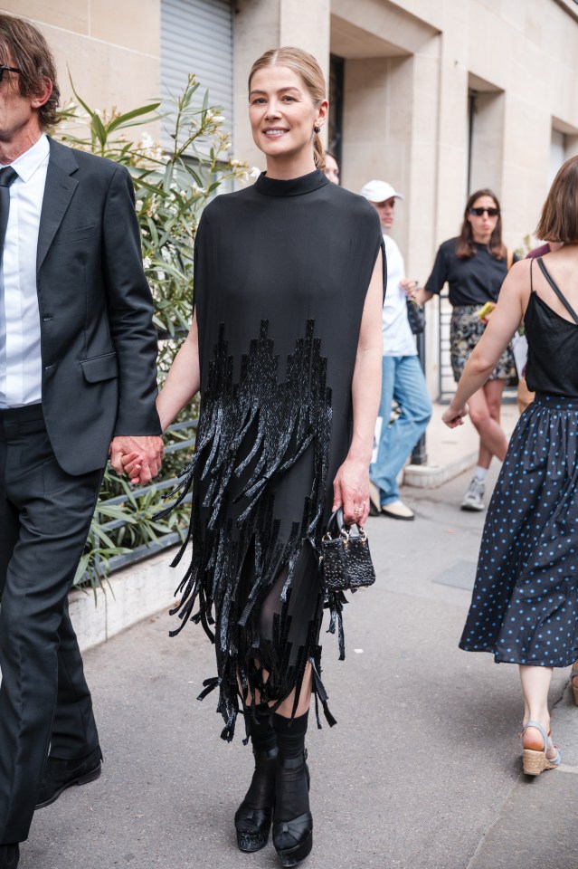 Rosamund Pike added black nylons to her heels for a Dior couture fashion show