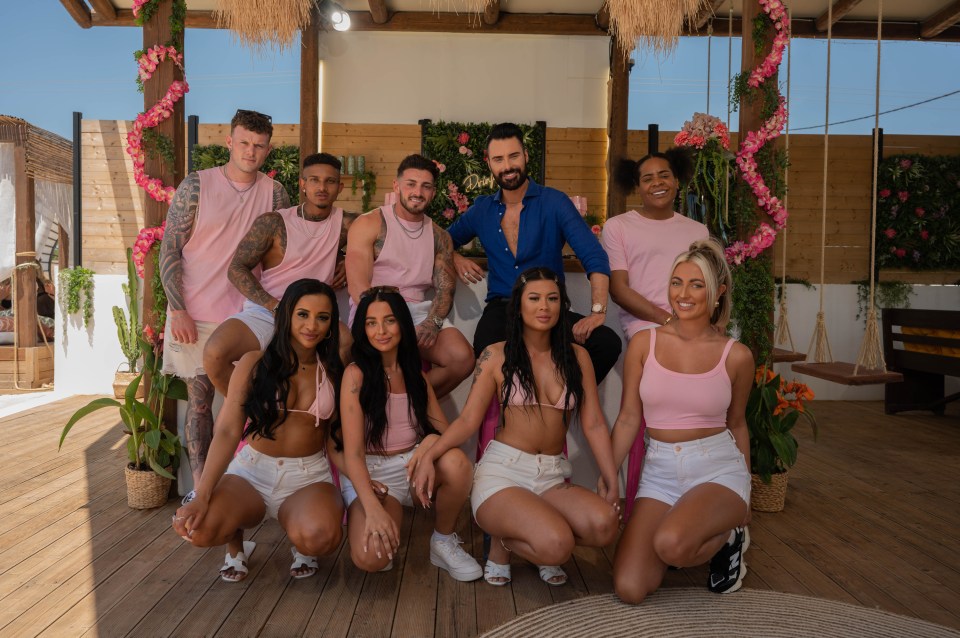 a group of men and women posing for a picture