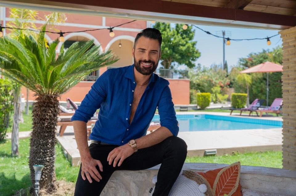 a man in a blue shirt is sitting in front of a pool