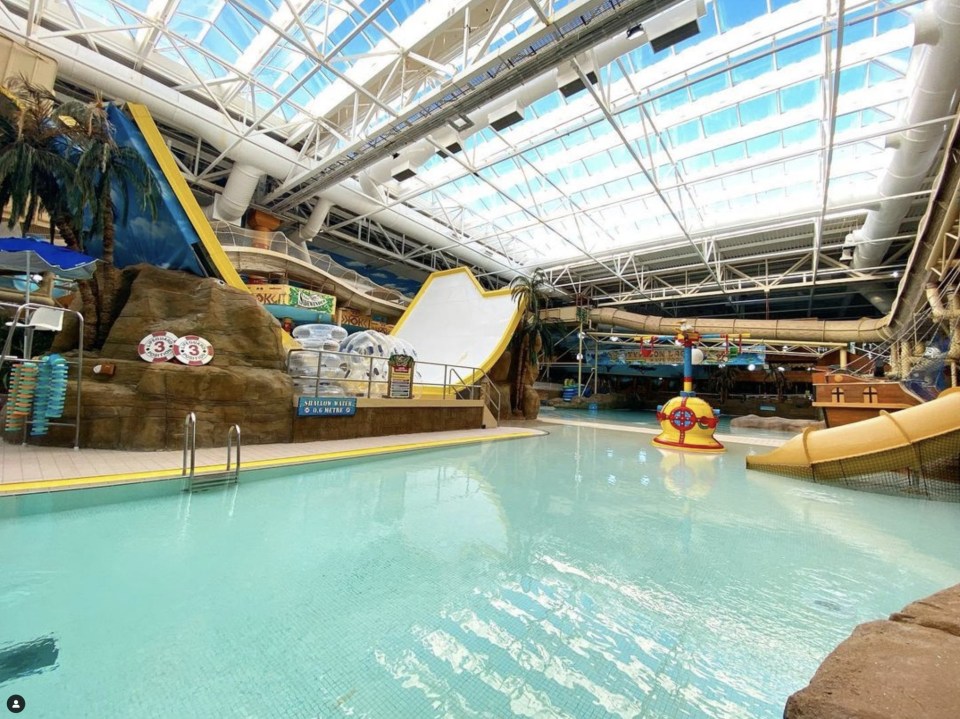 a large indoor water park with a sign that says no diving