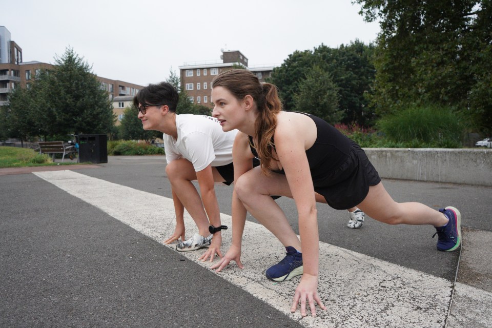 two women are getting ready to run on a street