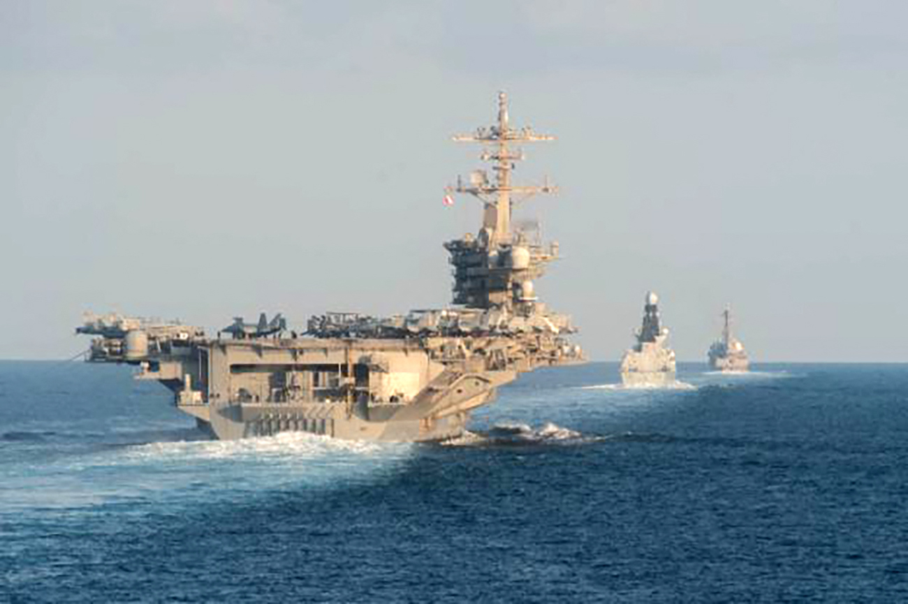 The USS Abraham Lincoln carrier strike warship (pictured) is set to replace the USS Theodore Roosevelt - currently out in the Middle East - as tensions rise