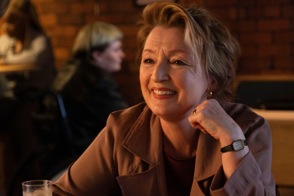 a woman with a watch on her wrist is smiling