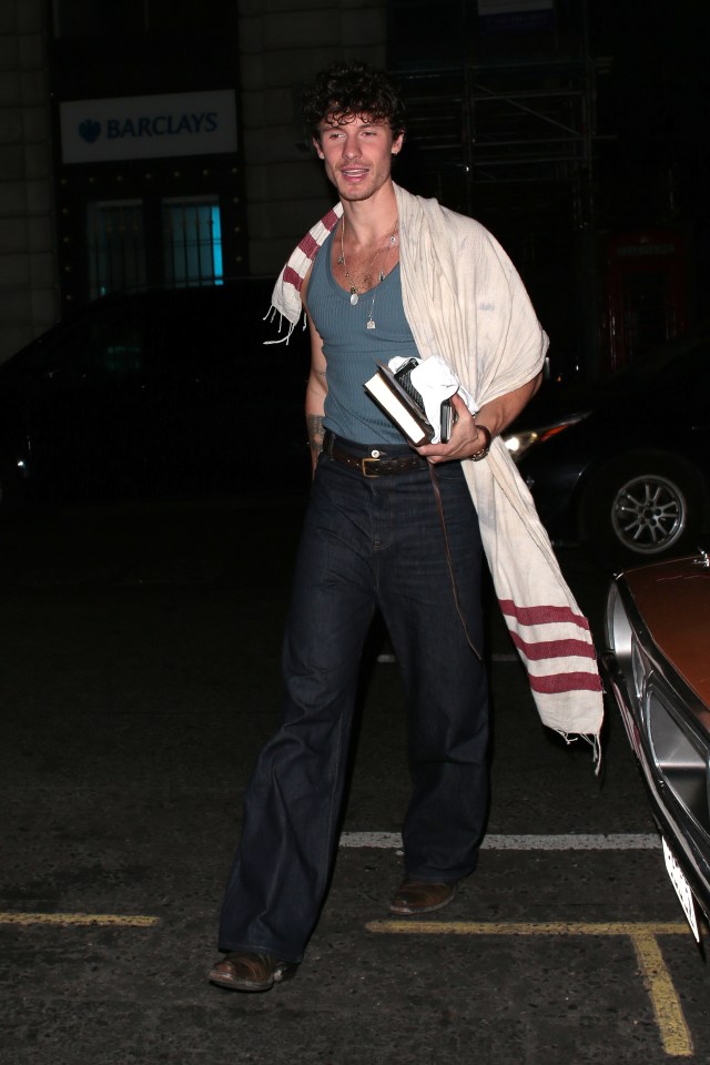 a man standing in front of a barclays sign